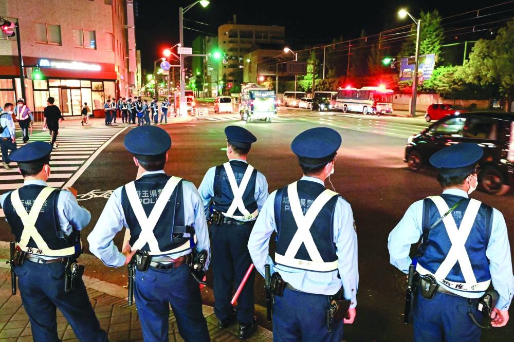 Police officers monitor traffic along a street at the end of the second day of the G7 Summit Leaders’ Meeting in Hiroshima, late on Saturday.