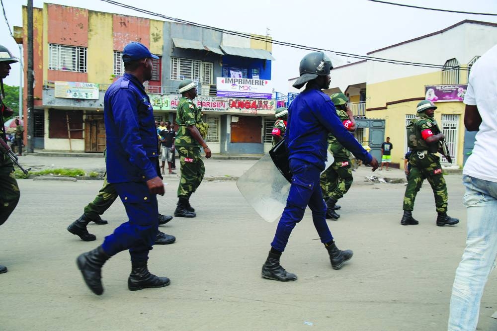 Security forces members patrol during the clashes with anti-government protesters in Kinshasa, Democratic Republic of Congo, Saturday.