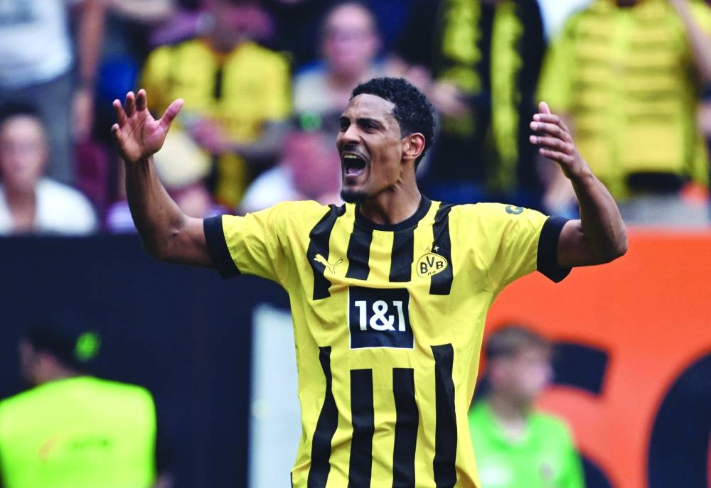 Dortmund’s Sebastien Haller celebrates scoring the opening goal during the Bundesliga match against FC Augsburg in Augsburg on Sunday. (AFP)