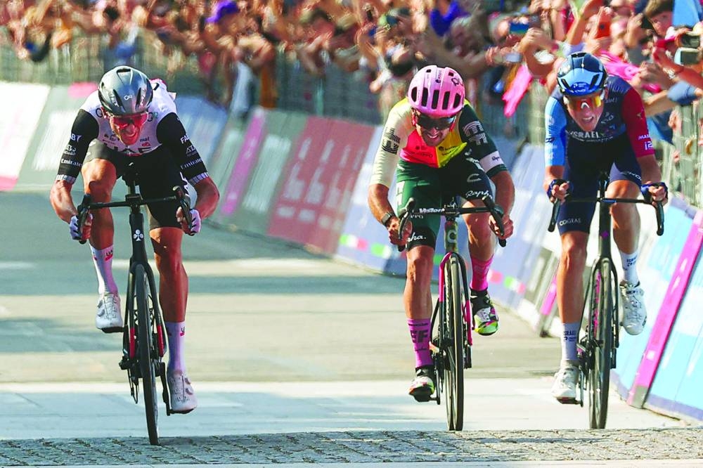 American rider Brandon McNulty (left) sprints in the last metres on his way to win the 15th stage Giro d’Italia 2023 ahead Irish rider Ben Healy (centre) and Italian rider Marco Frigo on Sunday. (AFP)