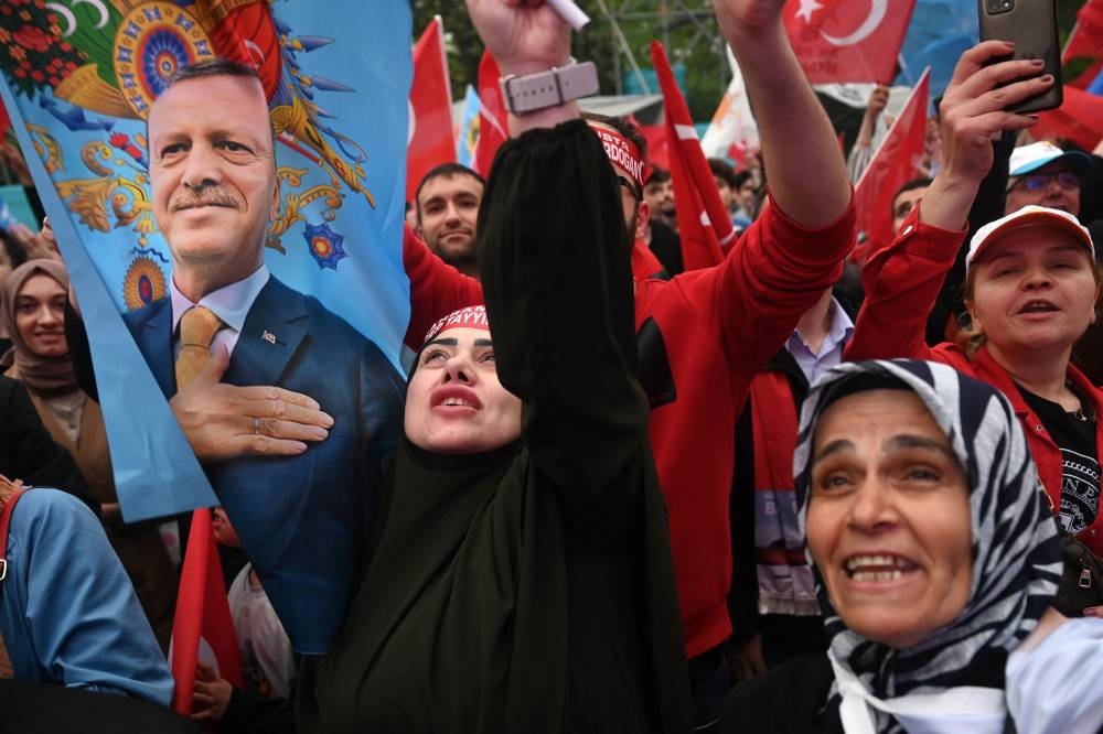 Supporters of Turkish President wave a flag depicting Recep Tayyip Erdogan in front of AK Party’s headquarter in Istanbul on the day of the Presidential runoff vote in Istanbul.