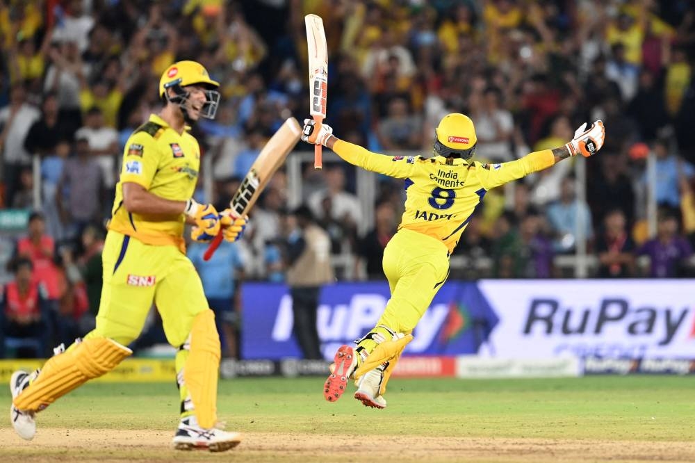 Chennai Super Kings' Ravindra Jadeja (right) and Shivam Dube celebrate their win at the end of the Indian Premier League (IPL) Twenty20 final cricket match between Gujarat Titans and Chennai Super Kings at the Narendra Modi Stadium in Ahmedabad on Monday. (AFP)