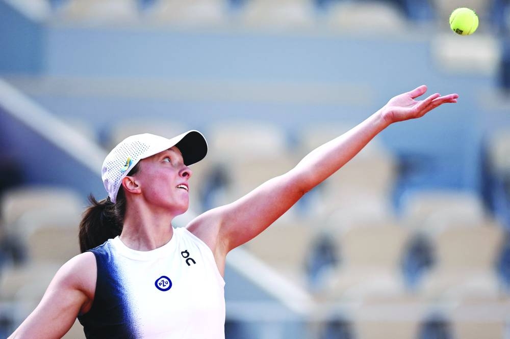Poland’s Iga Swiatek serves to Spain’s Cristina Bucsa during their French Open match on Tuesday. (AFP)