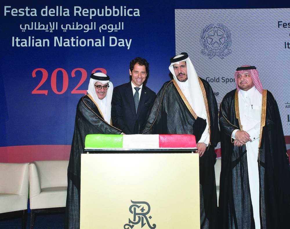 Italian ambassador Paolo Toschi is joined by Qatar's Minister of Commerce and Industry HE Sheikh Mohammed bin Hamad bin Qassim al-Abdullah al-Thani and HE the Minister of State and Qatar National Library president HE Dr Hamad bin Abdulaziz al-Kawari in cutting a cake at the event yesterday as Ministry of Foreign Affairs Department of Protocol director ambassador Ibrahim Fakhro looks on. PICTURES: Shaji Kayamkulam.