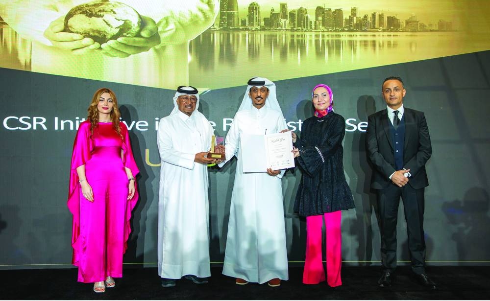 Engineer Abdullatif Ali al-Yafei, UDC executive director of Public Services, accepting the award on behalf of the company during the award ceremony.