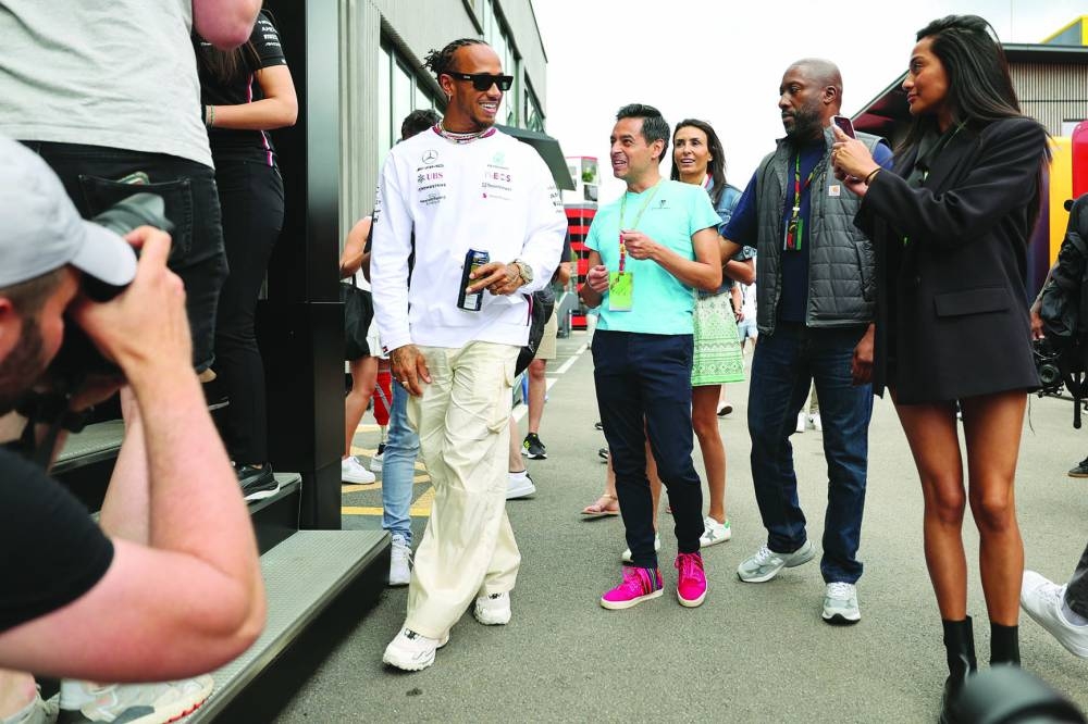 Mercedes’ British driver Lewis Hamilton (left) arrives at his team’s motorhome ahead of the Spanish Grand Prix at the Circuit de Catalunya in Montmelo, on the outskirts of Barcelona. (AFP)