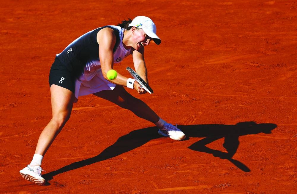 Poland’s Iga Swiatek in action during her second round match against Claire Liu of the US at the French Open in Paris on Thursday. (AFP)