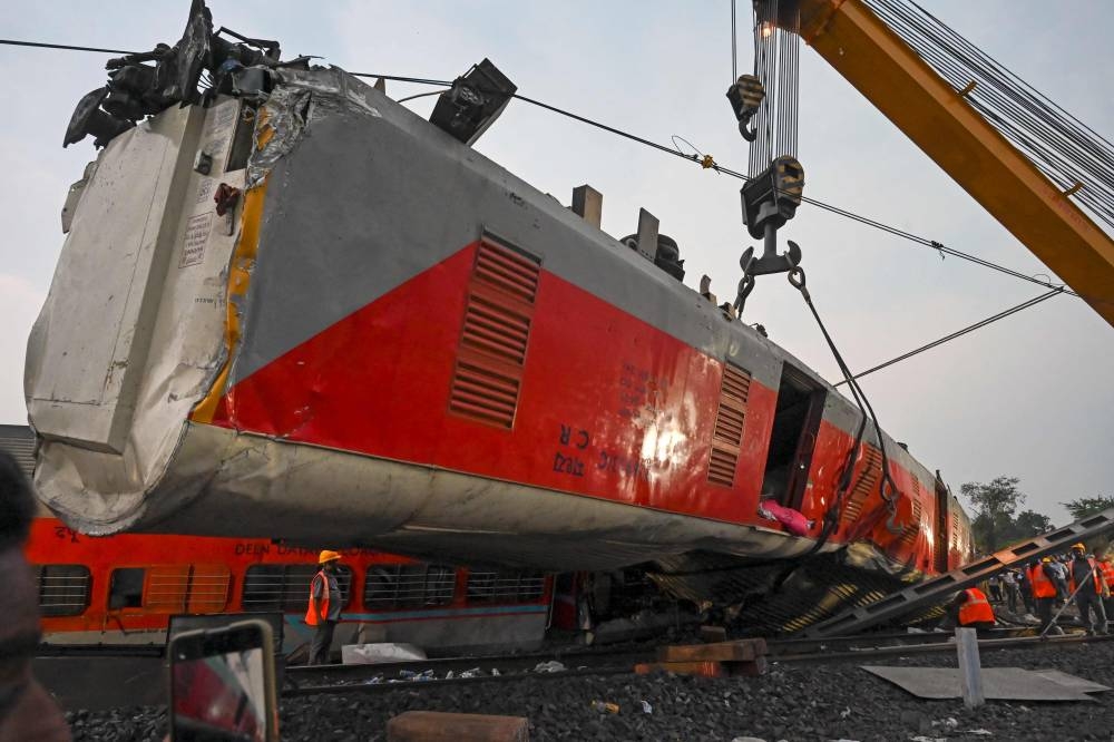 Rescue workers recover victims' bodies from a carriage wreckage of a three-train collision near Balasore, in India's eastern state of Odisha. DIBYANGSHU SARKAR / AFP
