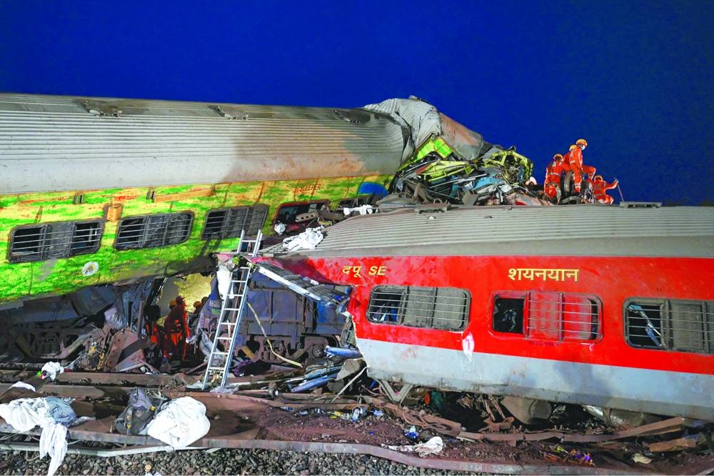 
Rescue workers recover victims’ bodies from the carriage wreckage of a three-train collision near Balasore. 