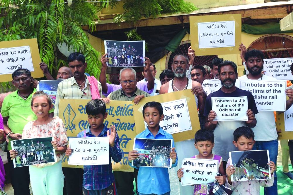 
People offer prayers for the victims and survivors of the three-train collision near Balasore. 