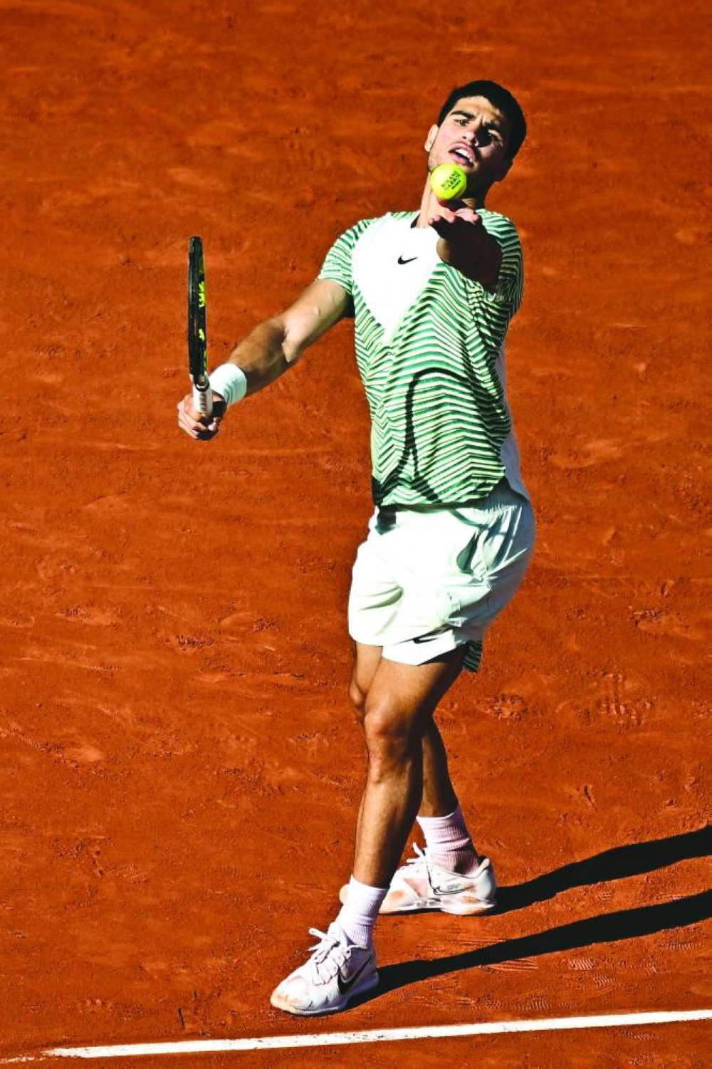 Spain’s Carlos Alcaraz Garfia serves to Italy’s Lorenzo Musetti during their French Open match in Paris on Sunday. (AFP)