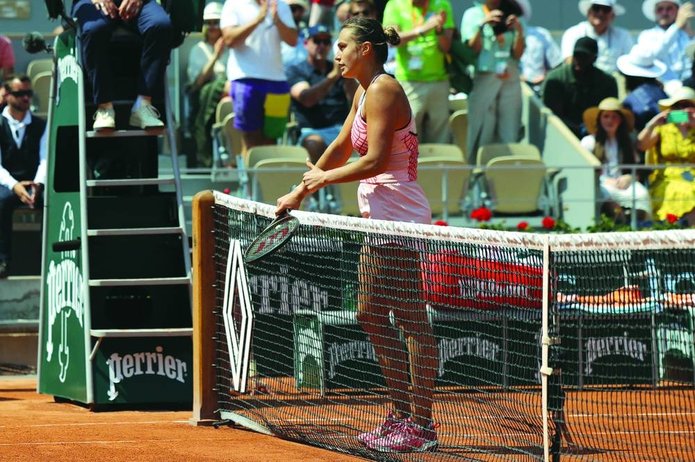 Belarus’ Aryna Sabalenka gestures a thumbs up as she waits to shake hands with Ukraine’s Elina Svitolina after winning the French Open quarter-final in Paris on Tuesday. (AFP)