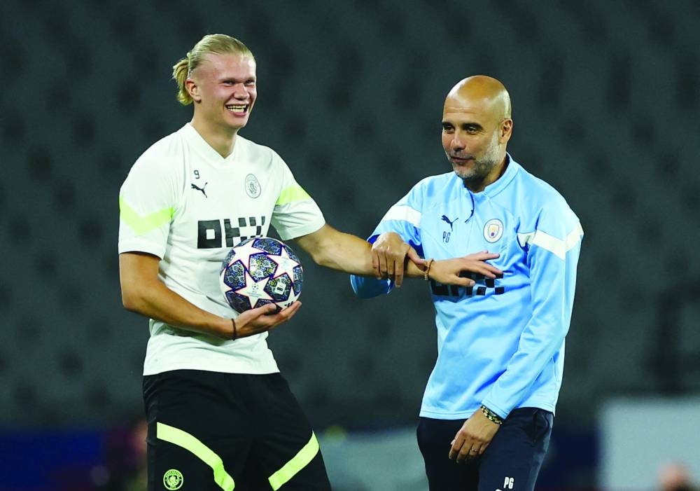 Manchester City manager Pep Guardiola (right) and striker Erling Haaland share a light moment during training session on Friday at the Ataturk Olympic Stadium in Istanbul, on the eve of the Champions League final against Inter Milan (Reuters)