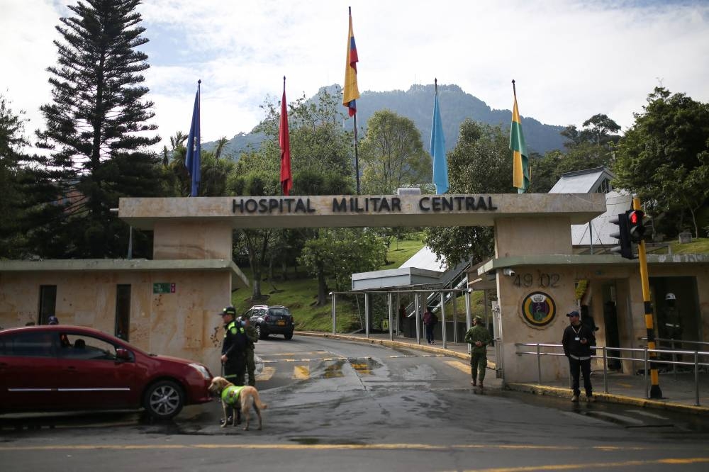 People stand outside the central military hospital, where the child survivors of a Cessna 206 plane that crashed in thick jungle are hospitalized, in Bogota, Colombia. REUTERS/Luisa Gonzalez