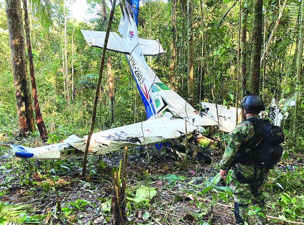 A soldier standing next to the wreckage of an aircraft that crashed in the Colombian Amazon forest in the municipality of Solano, department of Caqueta, on May 19, 2023. (AFP)