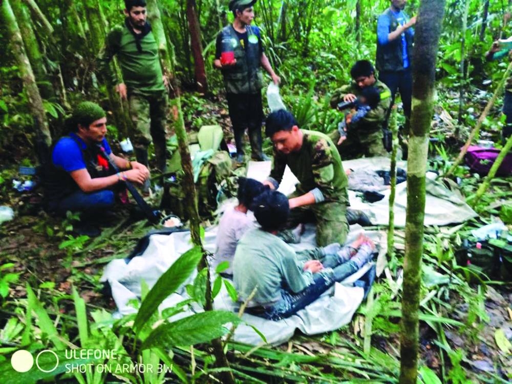 Members of the army assist the Indigenous children who were found alive. (AFP)