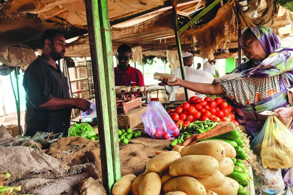 A woman buys vegetables at a market in Khartoum on Saturday during 24-hour ceasefire between Sudan’s warring generals.