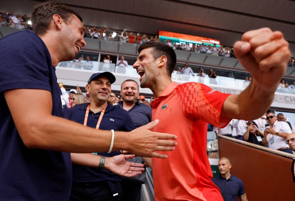 Serbia's Novak Djokovic celebrates with his team after winning the final against Norway's Casper Ruud. REUTERS/Christian Hartmann