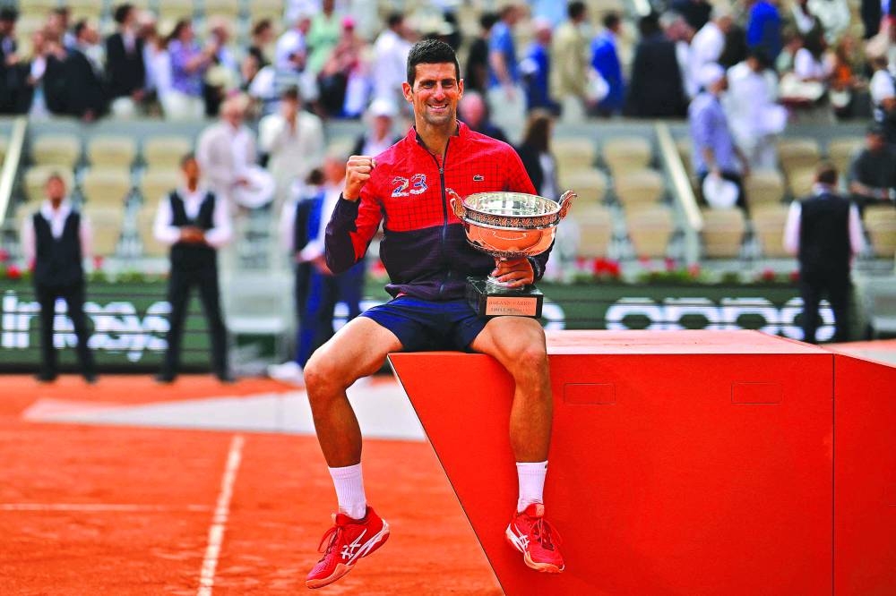 Serbia’s Novak Djokovic poses with the trophy as he celebrates his French Open win in Paris on Sunday. (AFP)