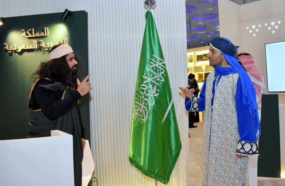 'Zaky' (left) presenting Al-Faw village to visitors at the 32nd DIBF. PICTURE: Thajudheen