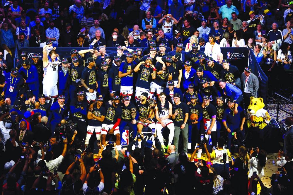 
The Denver Nuggets pose for a team photo with the Larry O’Brien Championship Trophy after their 94-89 victory against the Miami Heat in Game Five of the 2023 NBA Finals at Ball Arena in Denver, Colorado. (AFP) 