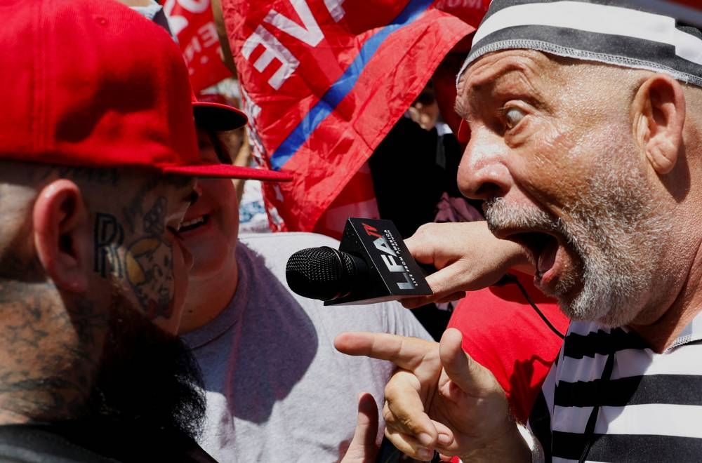 A supporter of former US President Donald Trump and an anti-Trump demonstrator argue near the Wilkie D. Ferguson Jr. United States Courthouse, on the Trump is to appear at his arraignment on classified document charges, in Miami, Florida. REUTERS/Marco Bello
