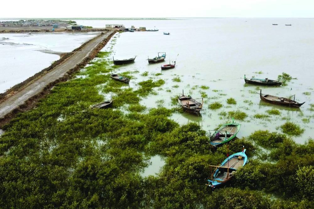 A general view of empty boats and houses at a coastal area of Keti Bandar in Thatta district of Pakistan’s Sindh province on Tuesday. (AFP)