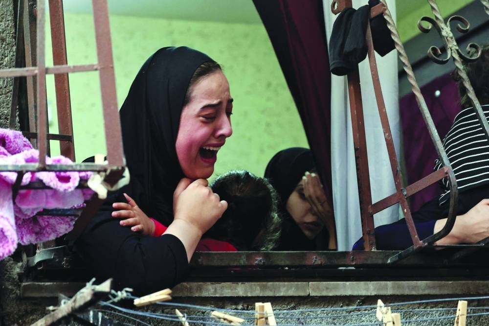 Relatives mourn during the funeral of Faris Hashash, 19, who was killed during clashes with Israeli forces at the Balata refugee camp on the outskirts of Nablus, in the occupied West Bank, on Tuesday.