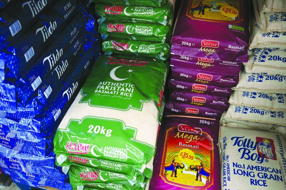 
 (Clockwise) Large bags of rice displayed for sale in Sonali Supermarket in the ‘Balti Triangle’ area of Birmingham, central England; ingredients used in the balti dish; Head Chef Zaf Hussain creates a balti dish in the kitchen of his restaurant Shababs; ready to be savoured balti dish. (AFP) 