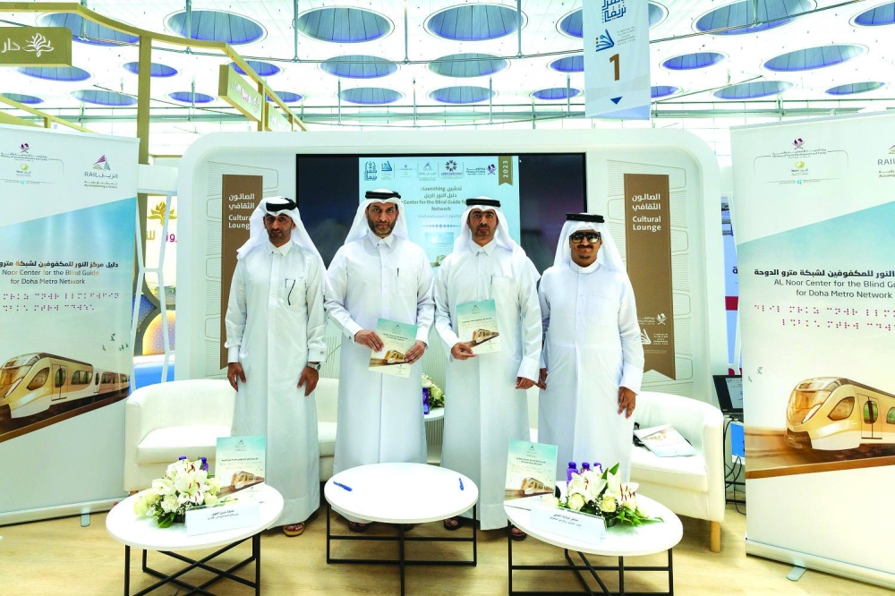 Officials of Qatar Rail and Al-Noor Centre for the Blind launch the 'Al-Noor Centre Guide for Doha Metro' at the Doha International Book Fair.