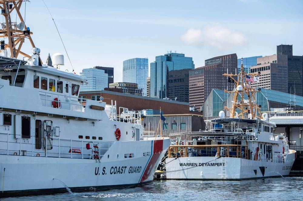 Crews work on Coast Guard vessels at Coast Guard Base Boston in Boston, Massachusetts. Joseph Prezioso / AFP