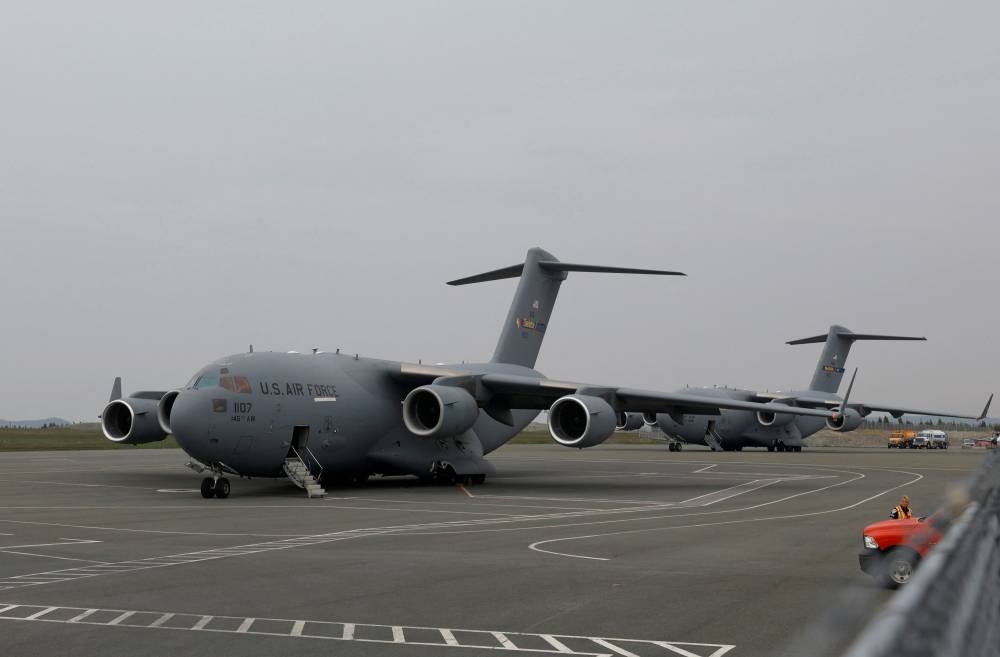 US Air Force Boeing C-17A Globemaster III aircrafts park on the tarmac following the updates on the missing OceanGate Expeditions submersible, which was carrying five people to explore the wreck of the sunken Titanic, at St John’s International Airport in St. John's, Newfoundland, Canada on June 22. REUTERS/David Hiscock