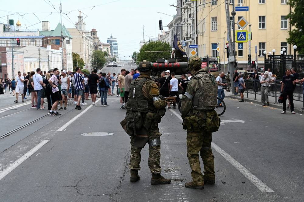 People gather in a street as fighters of Wagner private mercenary group are deployed near the headquarters of the Southern Military District in the city of Rostov-on-Don, Russia. REUTERS/Stringer