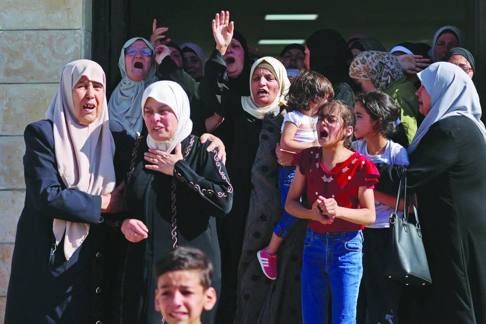 Palestinians react during the funeral of Tareq Erdis, who died from his wounds after being shot on Friday, during an Israeli operation in the Askar refugee camp, east of Nablus on Saturday.