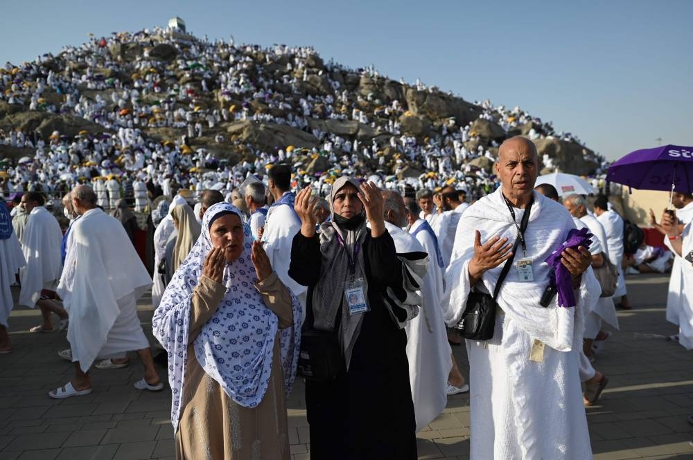 Libyan pilgrim Abdel Latif Abdel Wahab (right) prays along with family members in Saudi Arabia's Mount Arafat, during the Haj pilgrimage, yesterday.