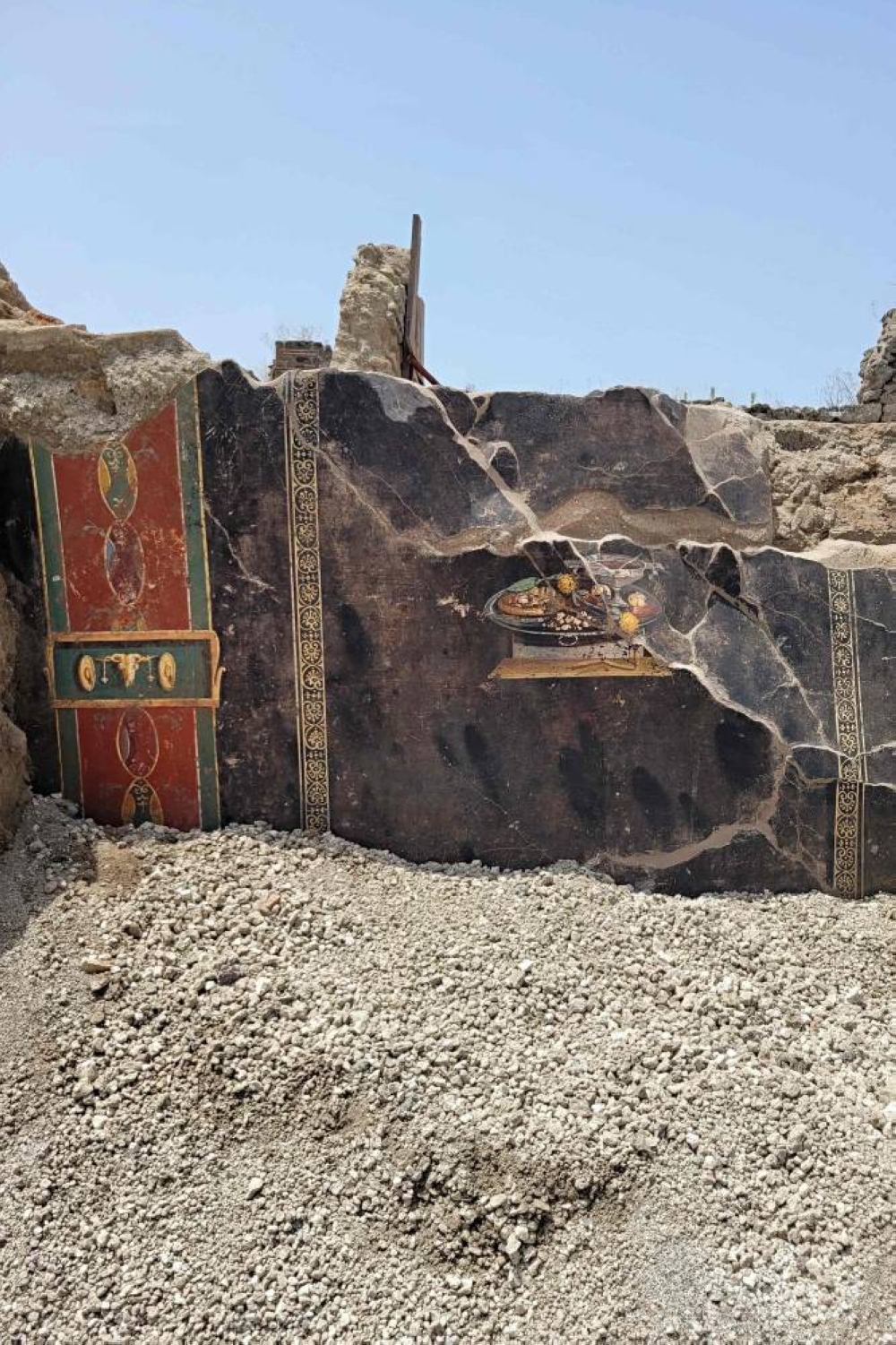 This handout photo taken and released on June 25 by Parco Archeologico di Pompei (Archaeological Park of Pompeii), shows a 2,000-year-old Pompeian painting, a still life, found by the new Regio IX excavations on the wall of an ancient Pompeian house, showing what could be a distant ancestor of modern pizza.