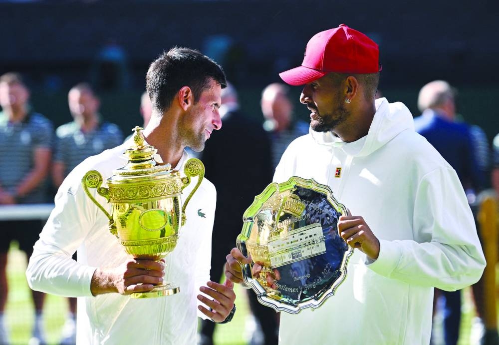 
Serbia’s Novak Djokovic poses with the trophy after winning the men’s singles final alongside runner up Australia’s Nick Kyrgios at the All England Lawn Tennis and Croquet Club, London, Britain, on July 10, 2022. (Reuters) 