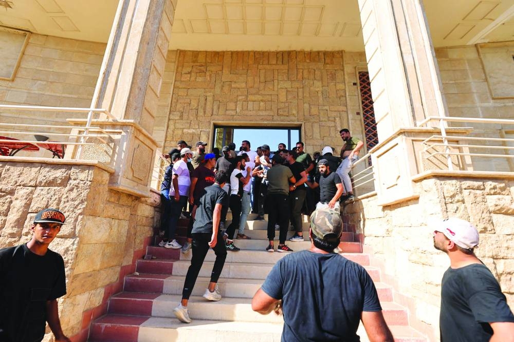 
Protesters are seen inside the courtyard of the Swedish embassy in Baghdad after they breached the building briefly. 