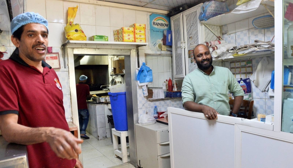 Harris Valluvacherry (right) with a staff member.