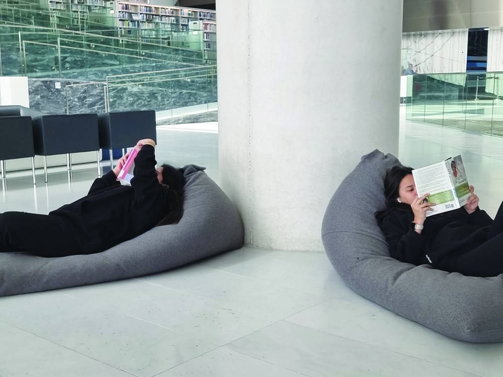 Thrisia Mae Rodriguez (left) and Khirzten Amber Tan enjoying the tranquil environment at the QNL yesterday. PICTURES: Joey Aguilar