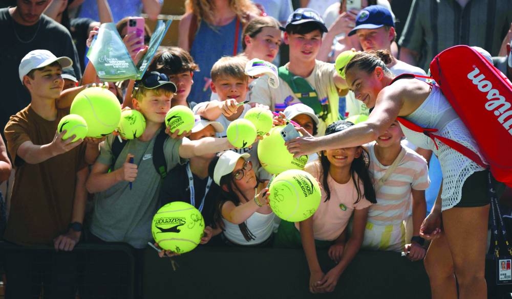 Belarus’ Aryna Sabalenka signs autographs after beating France’s Varvara Gracheva during their second round match on Friday. (AFP)
