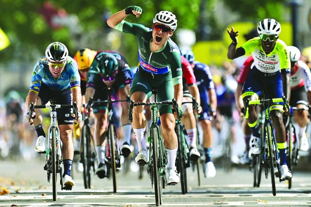 Alpecin-Deceuninck’s Belgian rider Jasper Philipsen (centre) cycles to the finish line to win the 7th stage of the 110th edition of the Tour de France cycling race, covering a distance of 170kms between Mont-de-Marsan and Bordeaux, in southwestern France, on Friday. (AFP)
