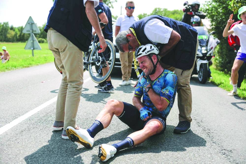 Astana Qazaqstan Team’s British rider Mark Cavendish receives medical attention after suffering a crash during the 8th stage of the 110th edition of the Tour de France in Limoges, France, on Saturday. (AFP)