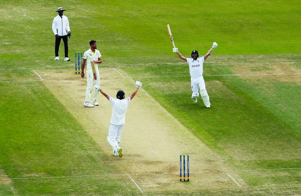 
England’s Chris Woakes and Mark Wood celebrate after winning the third Ashes Test against Australia on the fourth day at Headingley, Leeds, yesterday. (Reuters) 