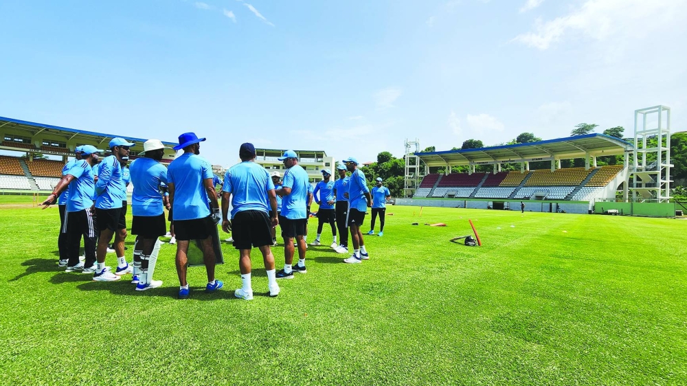 India's players huddle up prior to a team training session in Dominica. 