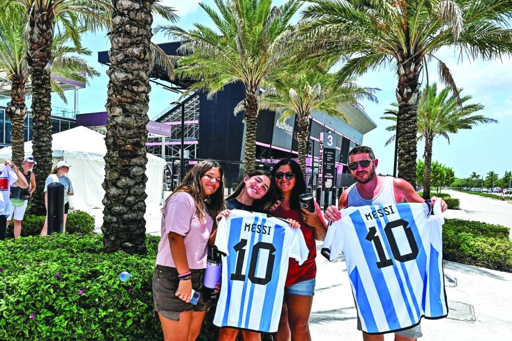 Fans of Argentine football player Lionel Messi pose for a photo while waiting for his arrival at the DRV PNK Stadium in Fort Lauderdale, Florida, on Tuesday, ahead of Messi’s debut in the Major League Soccer (MLS) with Inter Miami. (AFP)