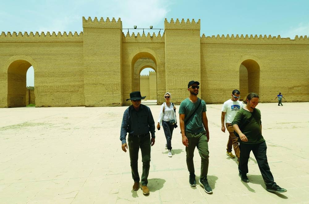 Anna Nikolaevna, 38, a Russian national, and Jacob Nemec, 29, an American national, walk during a tour in the ancient city of Babylon, Iraq.