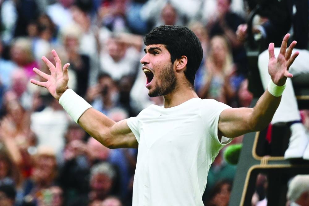 Spain’s Carlos Alcaraz celebrates beating Russia’s Daniil Medvedev in Wimbledon semi-final on Friday. (AFP)