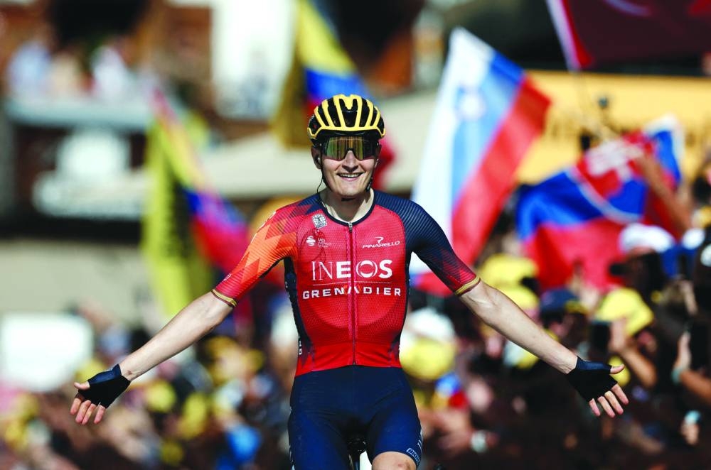 Ineos Grenadiers’ Carlos Rodriguez celebrates as he crosses the finish line to win stage 14 of the Tour de France on Saturday. (Reuters)