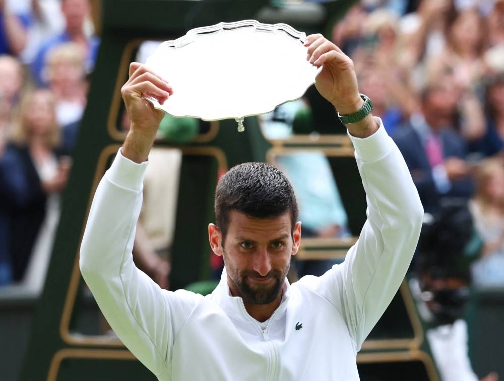 Serbia's Novak Djokovic with the runners up trophy after losing to Spain's Carlos Alcaraz in the men's final. REUTERS/Toby Melville